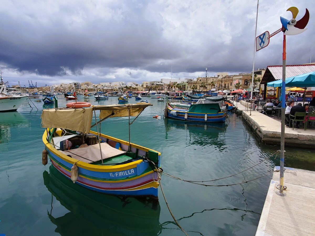 Colourful Maltese fishing boats in Marsaxlokk harbour