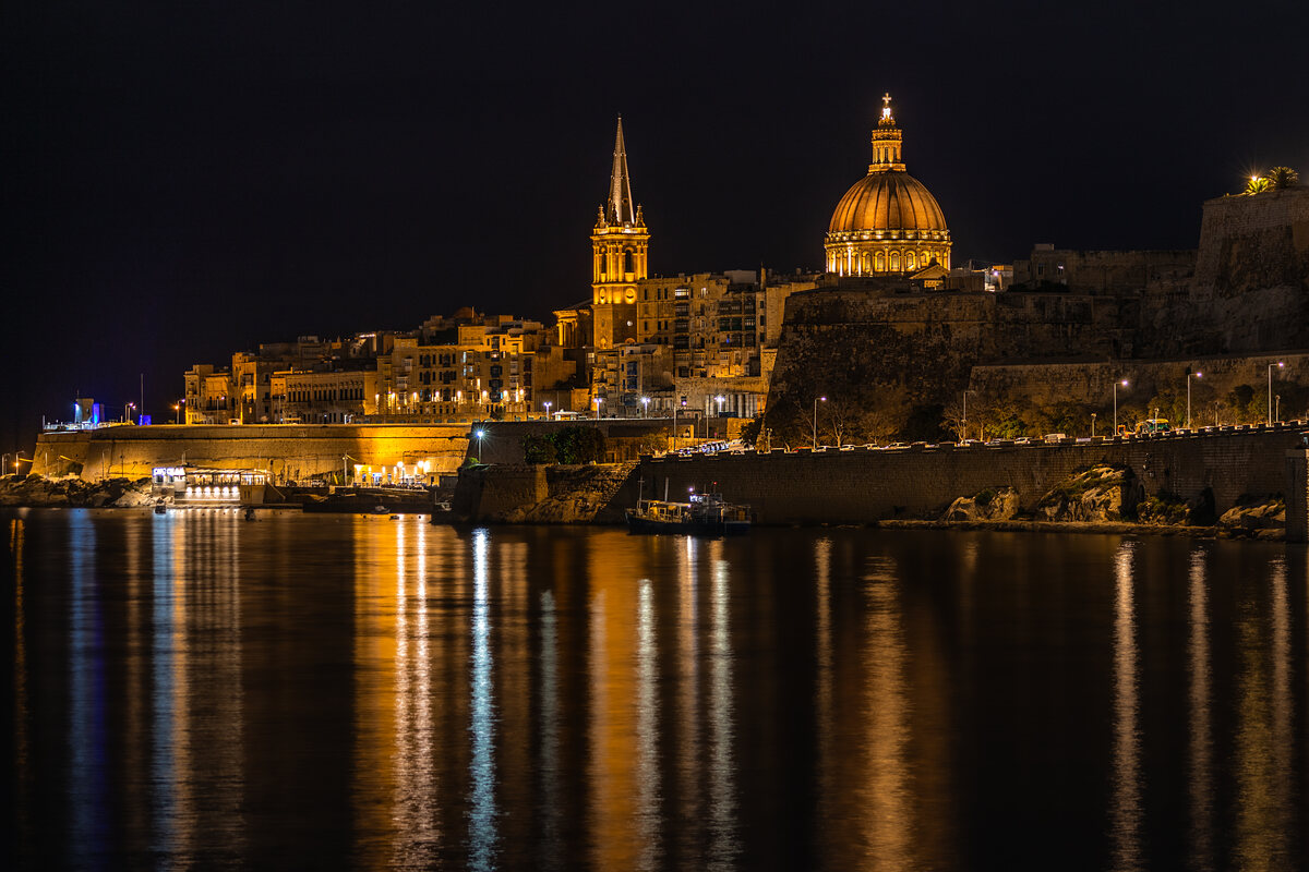 Valletta’s illuminated skyline and reflections across the harbour at night